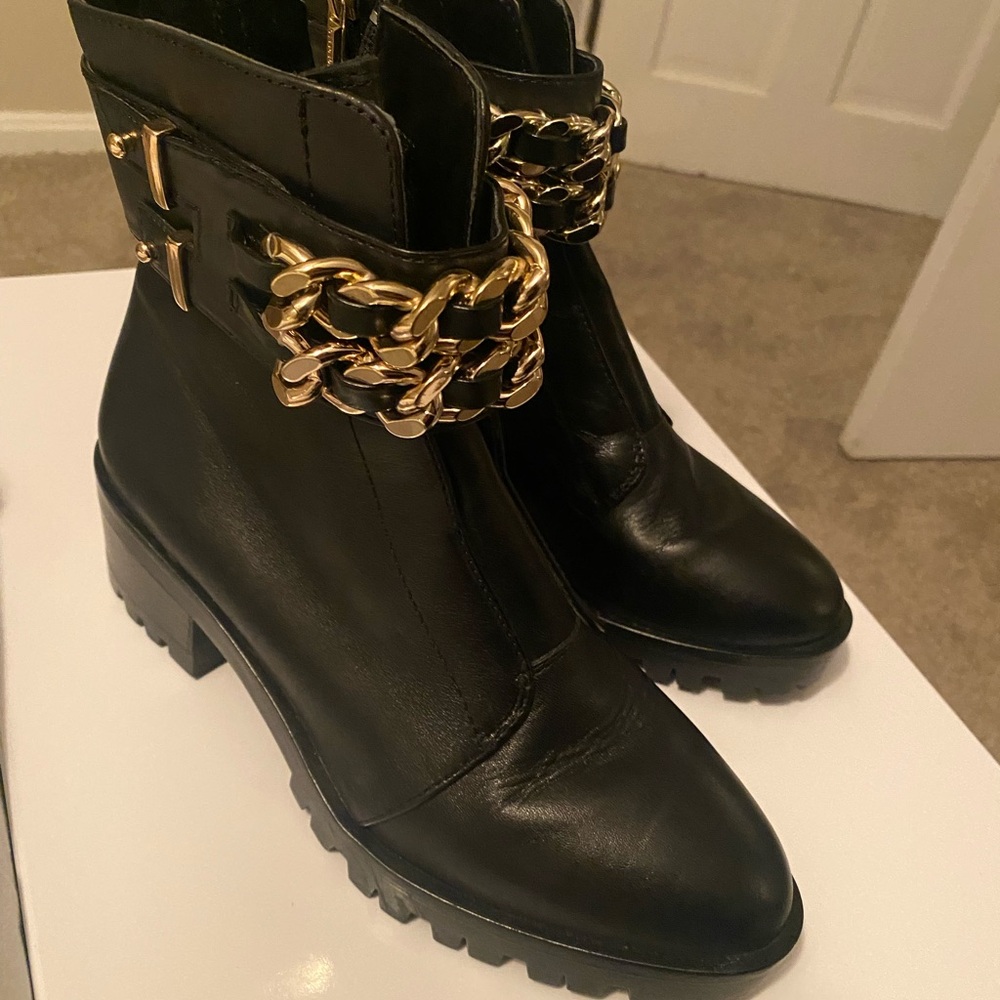 Chic black combat boots with gold chain